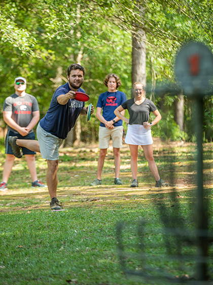 Students playing disc golf.